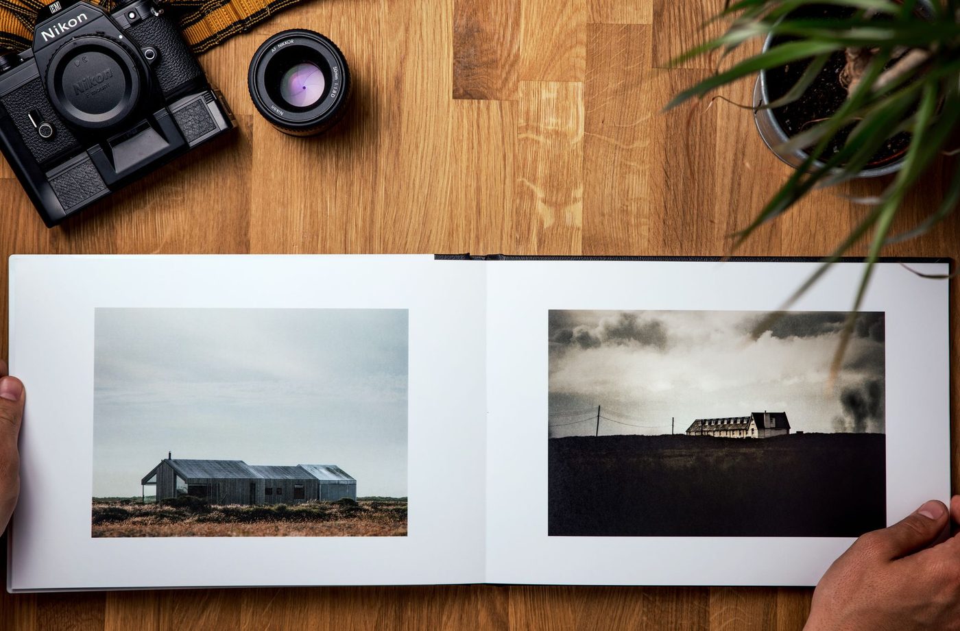 Open photo book with two landscape photos, seen from above